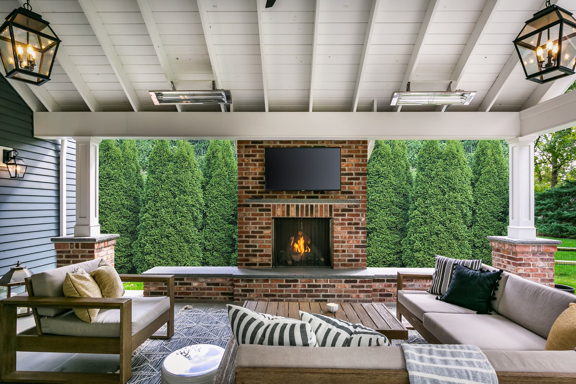 Covered outdoor living room with a fireplace
