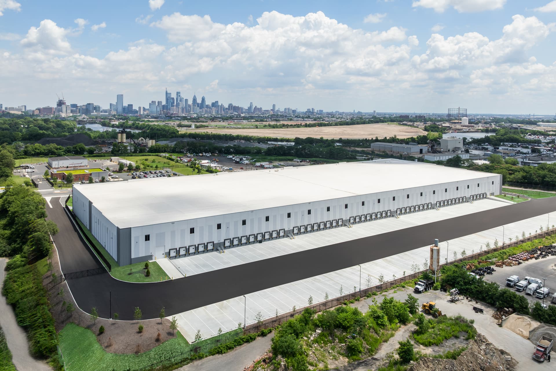 Aerial of a logistics facility with the Philadelphia skyline beyond