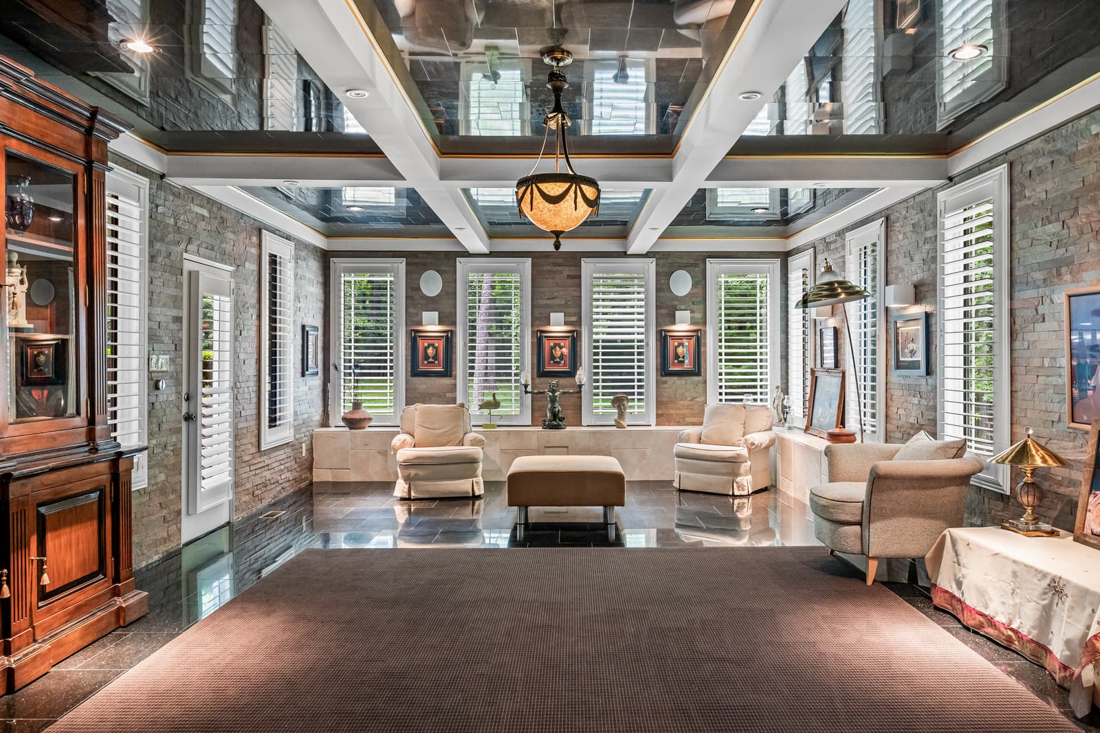 Grand living room with a stone wall and mirrored ceiling in Cherry Hill, NJ