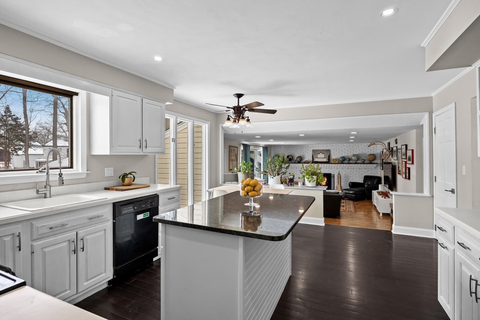 White kitchen with a dark island open to the living area in Cherry Hill, NJ