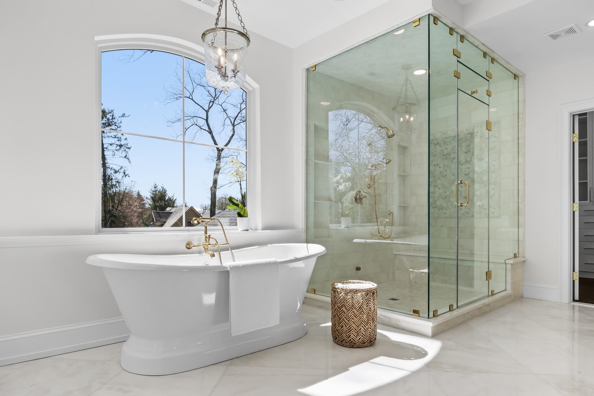 Spa bathroom with a freestanding soaking tub and glass shower in a Moorestown home