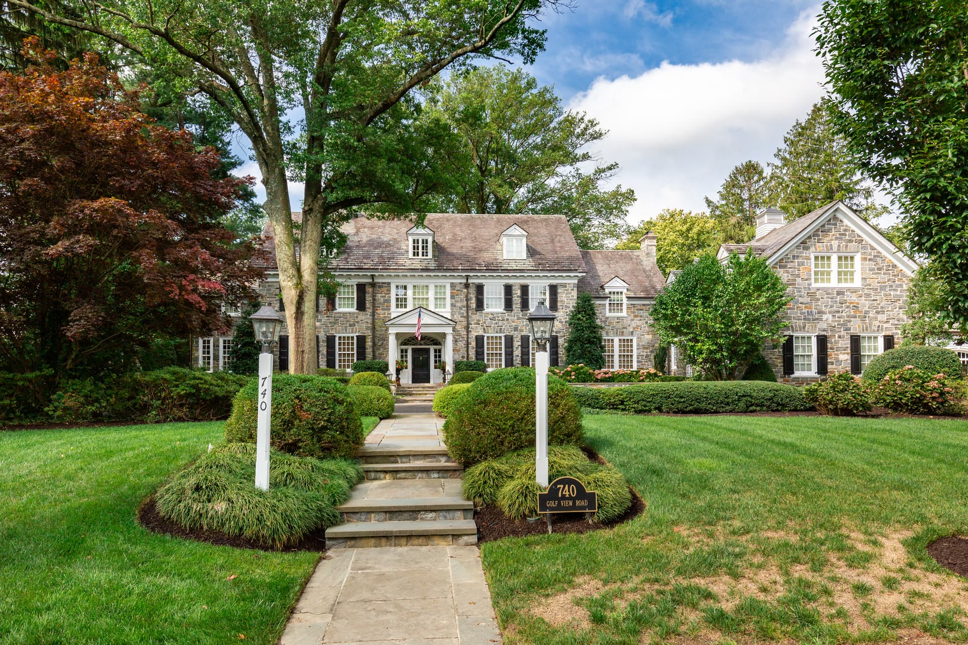 Front exterior of a Moorestown home with a manicured lawn and walkway